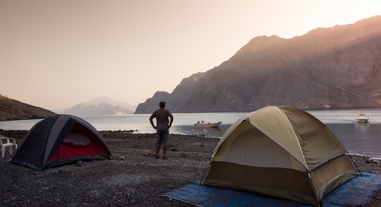 Enjoying the early morning sunrise at a camping trip to Kassab, Musandam, Oman.; Shutterstock ID 1122297419; your: Brian Healy; gl: 65050; netsuite: Lonely Planet Core Demand; full: Oman on a budget