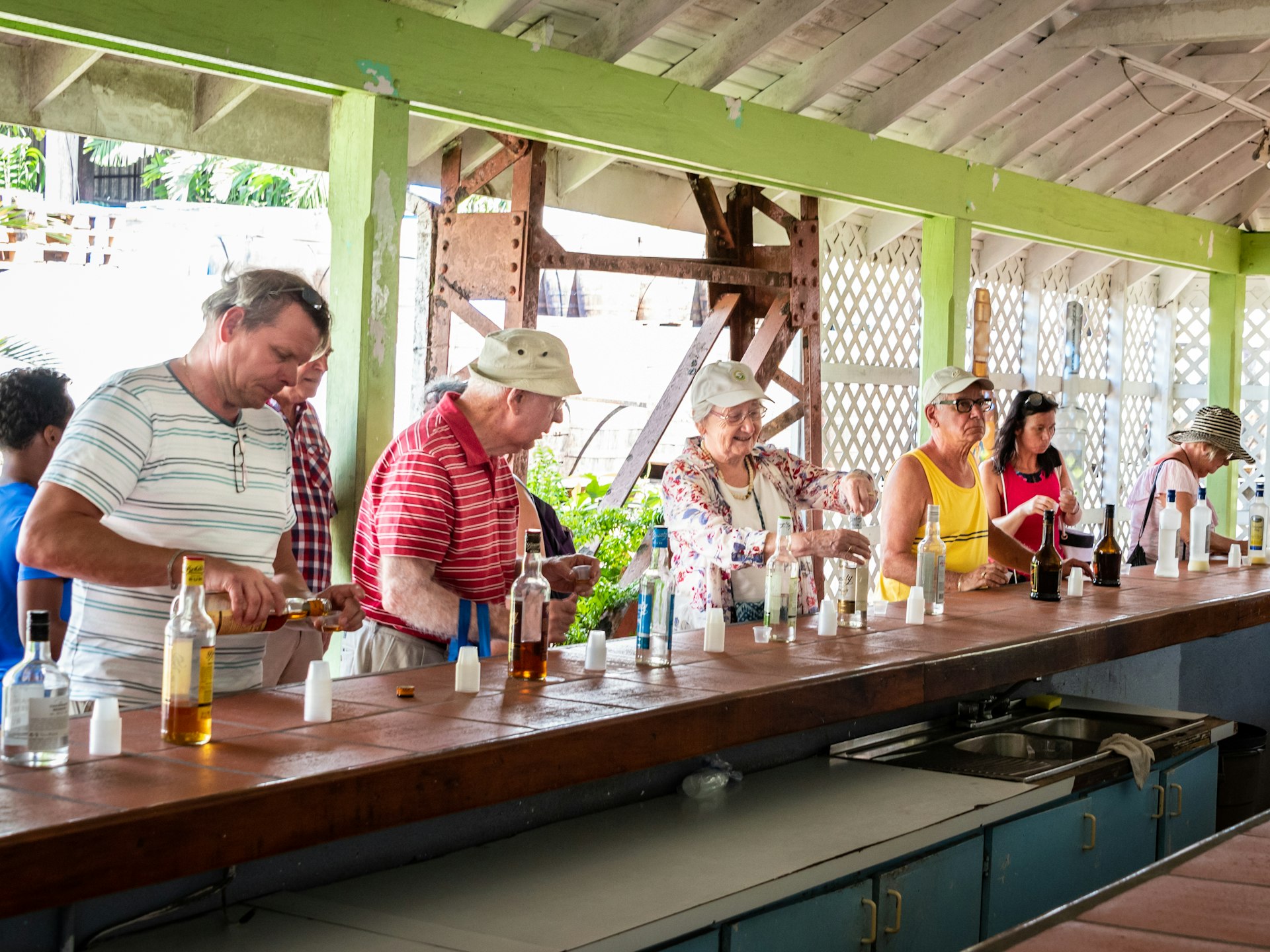 Tourists sampling rums at a bar at St Lucia Distillers