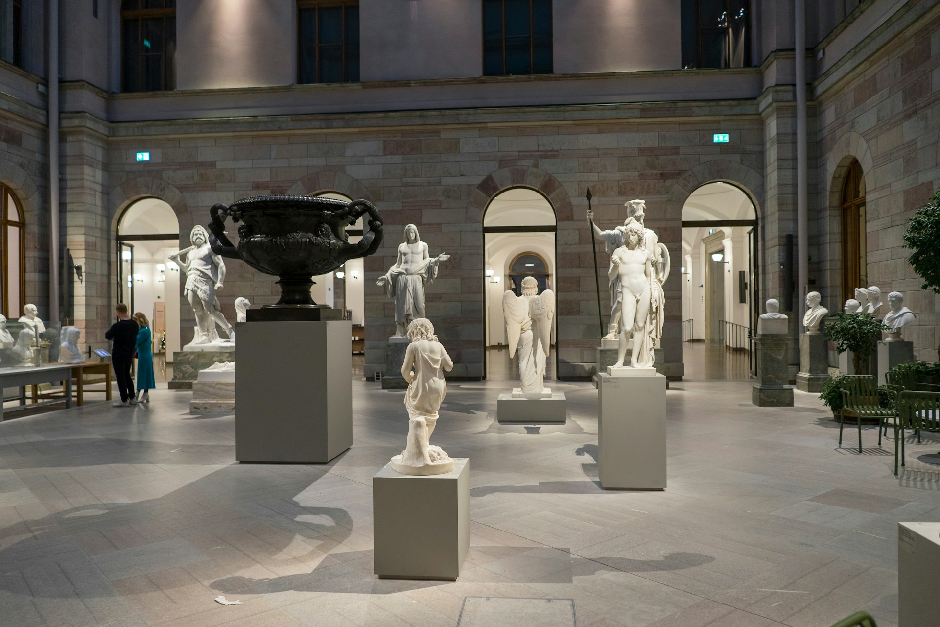 Dramatically lit sculptures in a gallery by night at the Nationalmuseum in Stockholm