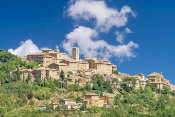 Stunning view of the Tuscan hilltop village of Montepulciano, Siena, Italy, on a sunny day with some white clouds