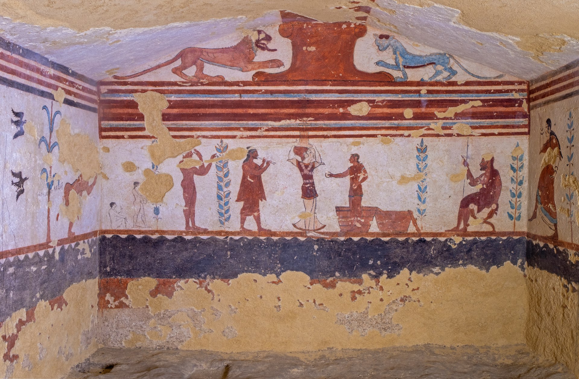 Red figures, blue and red animals and floral motifs in the painted funeral chambers at the ancient Etruscan tombs of Tarquinia