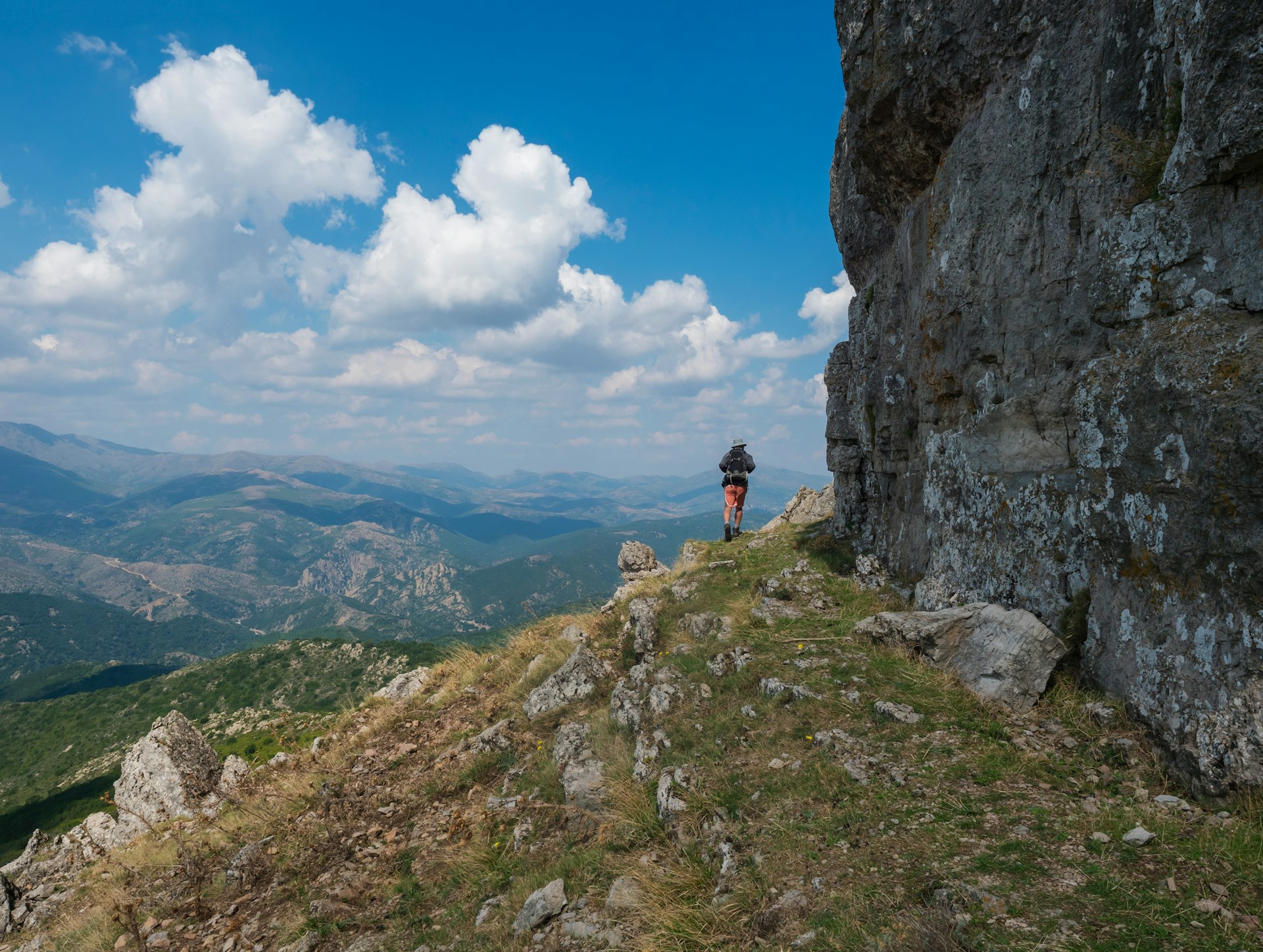 Man hiking around limestone tower Perda Liana, National Park of Barbagia, Sardinia, Italy