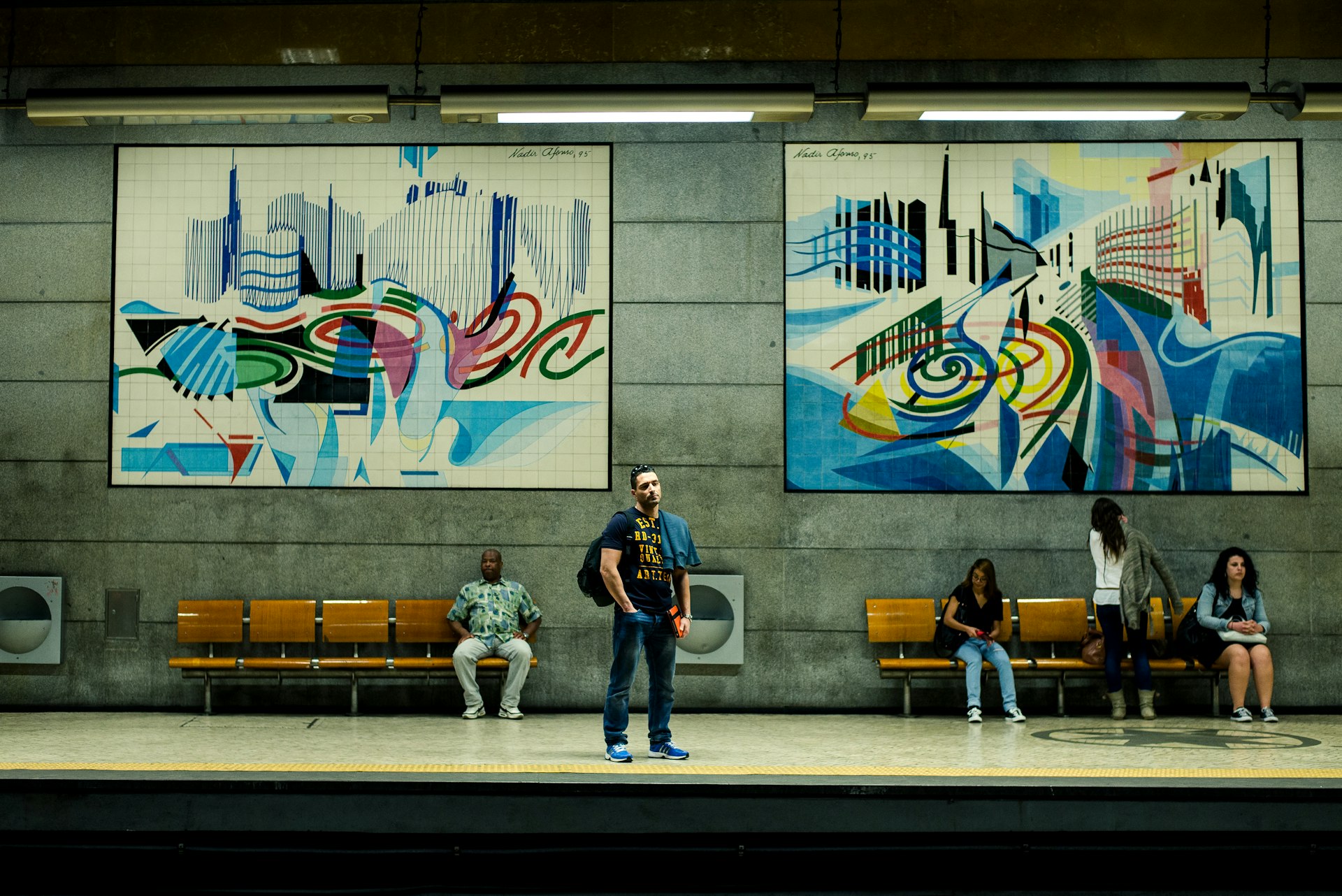 People waiting at an art-filled underground station in Lisbon