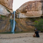 Woman Sitting in front of the Lower Calf Creek Falls, Calf Creek, Grand Staircase-Escalante National Monument, south Utah, USA; Shutterstock ID 335456882; your: Brian Healy; gl: 65050; netsuite: Online Editorial; full: Best beaches in Utah