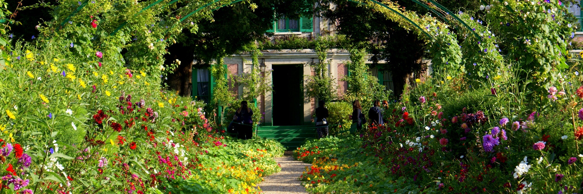 A green archway with flowers at Claude Monet's garden at Giverny.