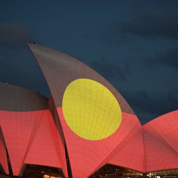 SYDNEY, AUSTRALIA - JANUARY 26: The Aboriginal flag is projected onto the sails of the Opera House during the Australia Day Live concert on January 26, 2022 in Sydney, Australia. Australia Day, formerly known as Foundation Day, is the official national day of Australia and is celebrated annually on January 26 to commemorate the arrival of the First Fleet to Sydney in 1788. Indigenous Australians refer to the day as 'Invasion Day' and there is growing support to change the date to one which can be celebrated by all Australians. (Photo by James D. Morgan/Getty Images)