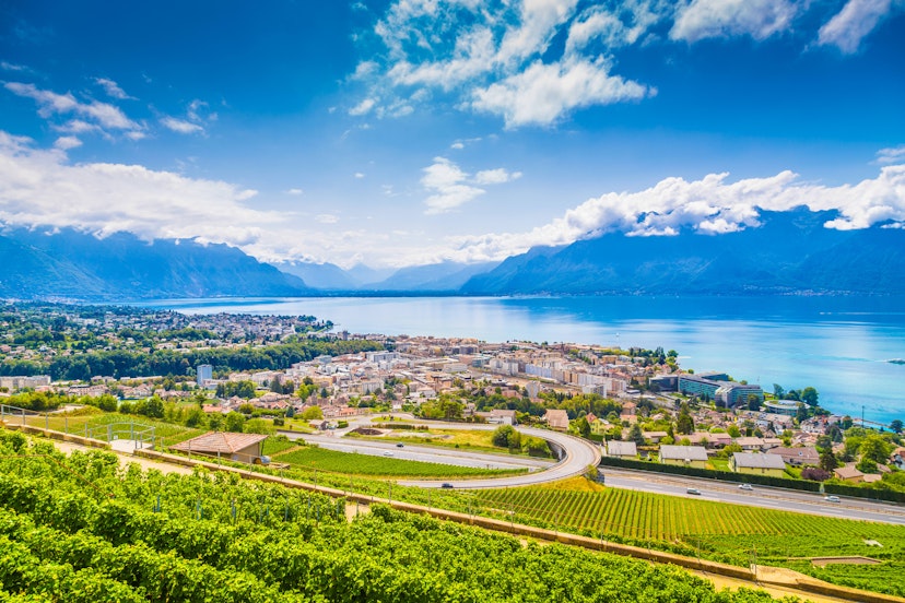Aerial panoramic view of the city of Vevey at Lake Geneva with vineyards of famous Lavaux wine region on a beautiful sunny day in summer, Switzerland.