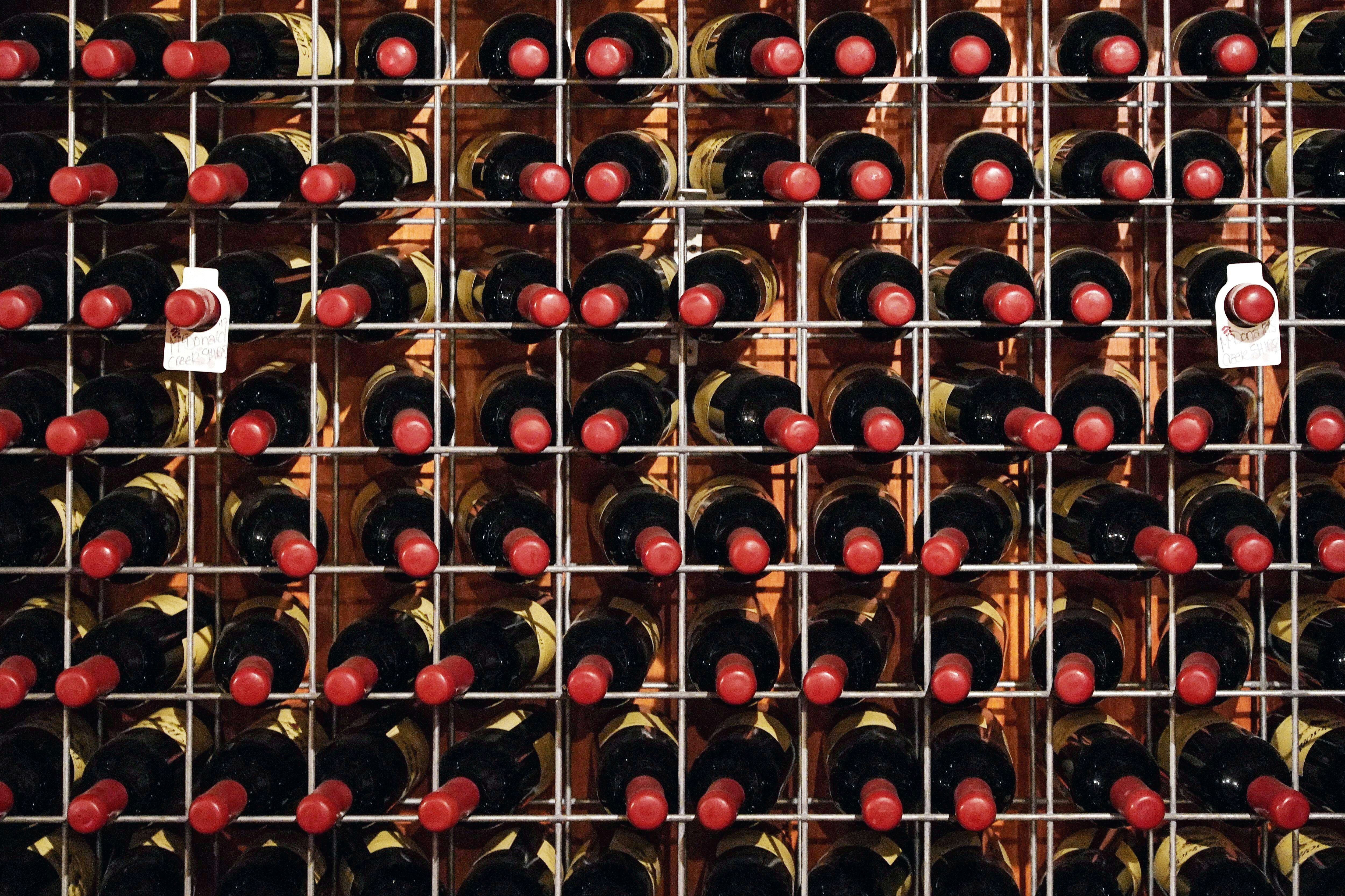2H6HE7C Bottles of wine sit on racks inside the cellar door tasting room at Petersons Wines, as wineries in the Hunter Valley region re-open to patrons following widespread coronavirus disease (COVID-19) lockdown in the state of New South Wales, in Mount View, Australia, November 14, 2021. Picture taken November 14, 2021.  REUTERS/Loren Elliott