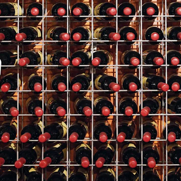 2H6HE7C Bottles of wine sit on racks inside the cellar door tasting room at Petersons Wines, as wineries in the Hunter Valley region re-open to patrons following widespread coronavirus disease (COVID-19) lockdown in the state of New South Wales, in Mount View, Australia, November 14, 2021. Picture taken November 14, 2021. REUTERS/Loren Elliott