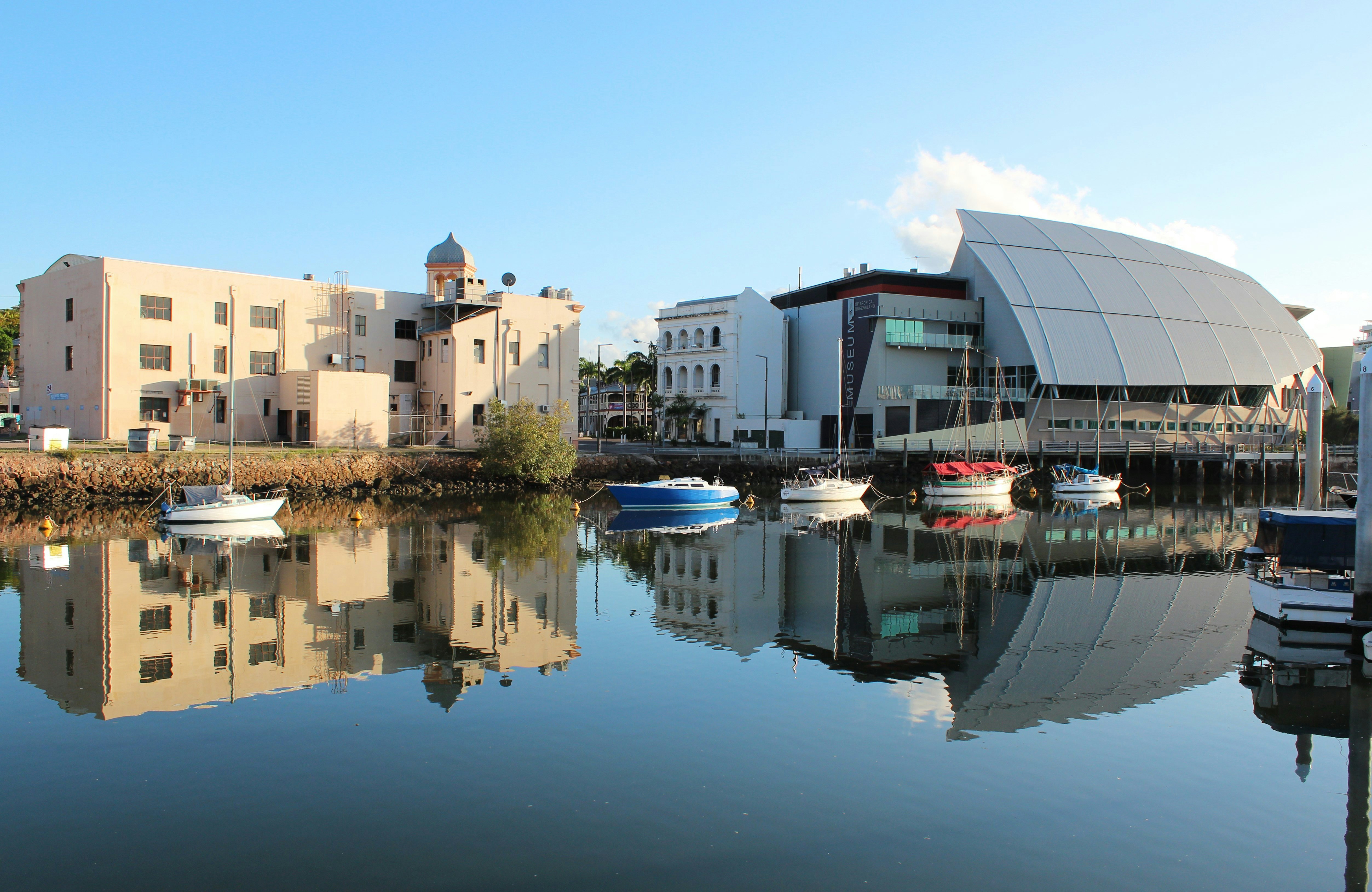 Bullwinkles Nightclub and Museum of Tropical Queensland (pictured at right) with reflection in water, Townsville. Australia
