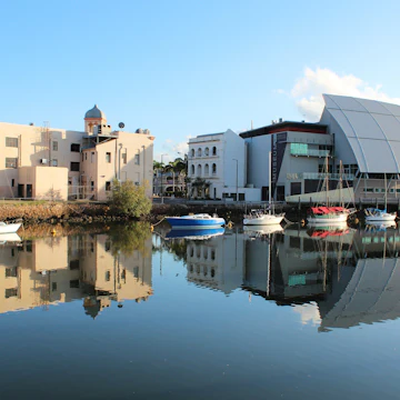 Bullwinkles Nightclub and Museum of Tropical Queensland (pictured at right) with reflection in water, Townsville. Australia