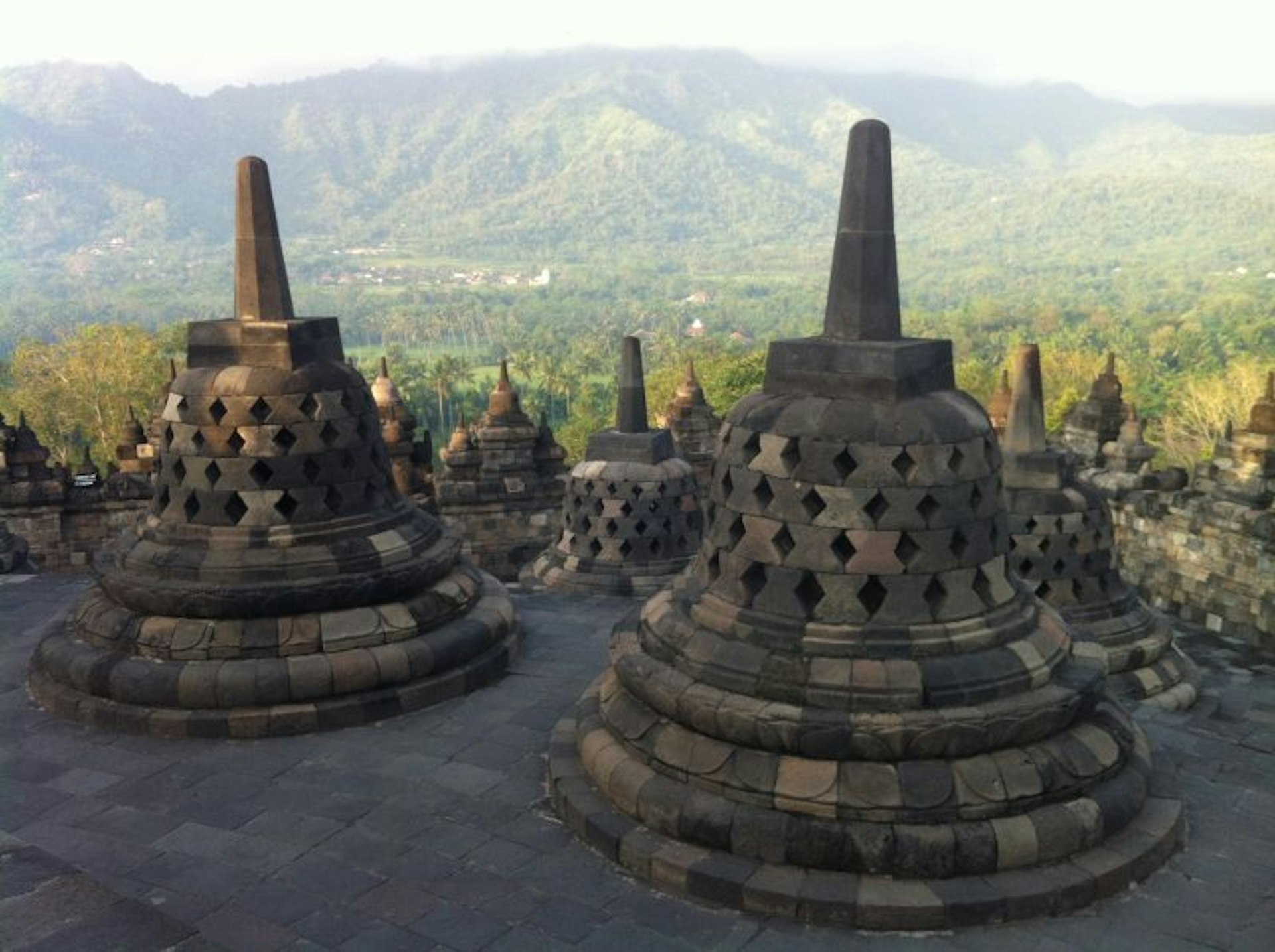 View of Borobudur in Central Java with treed hills in the distance