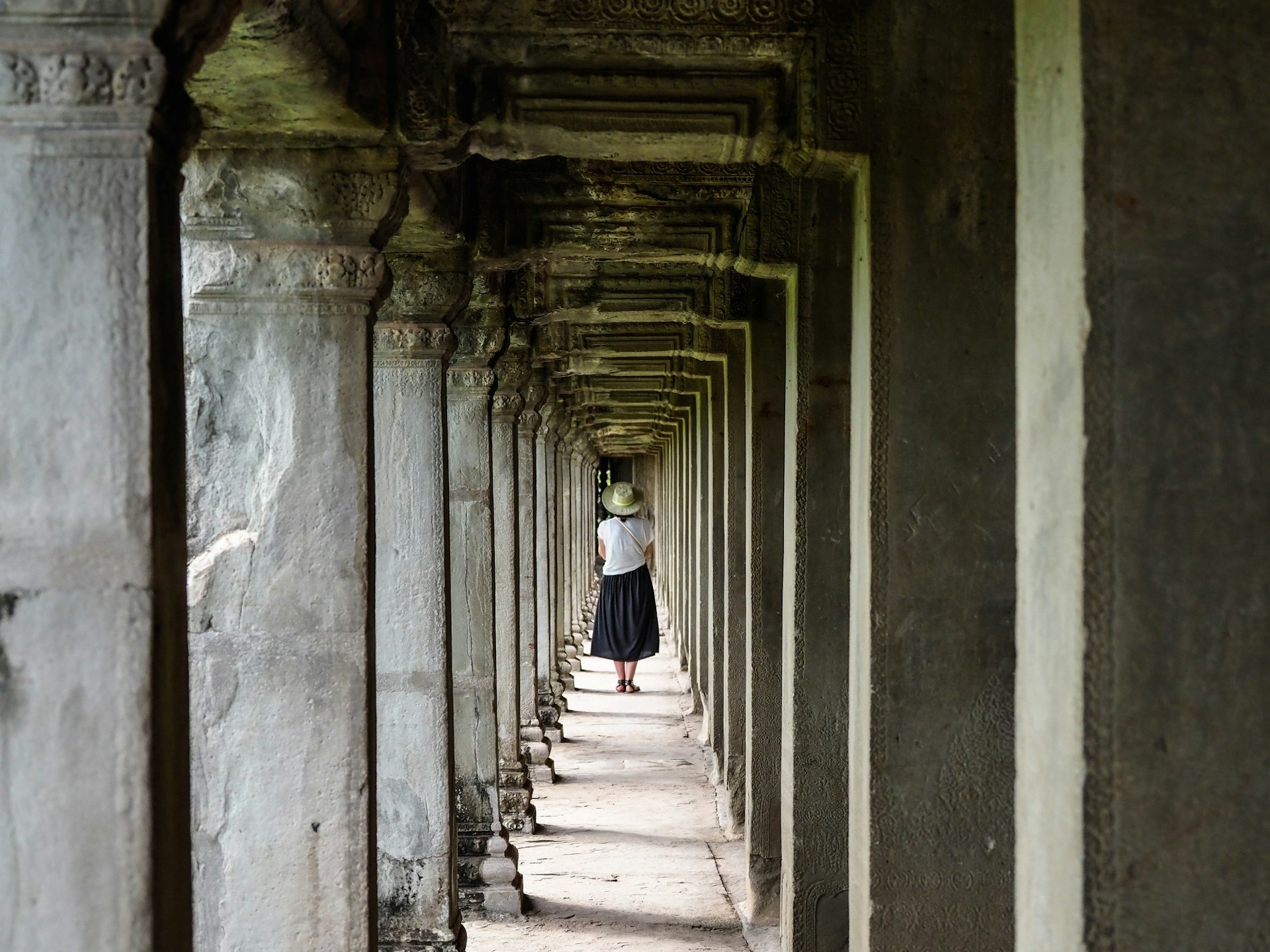 Rear View Of Woman Walking In Corridor Of Building