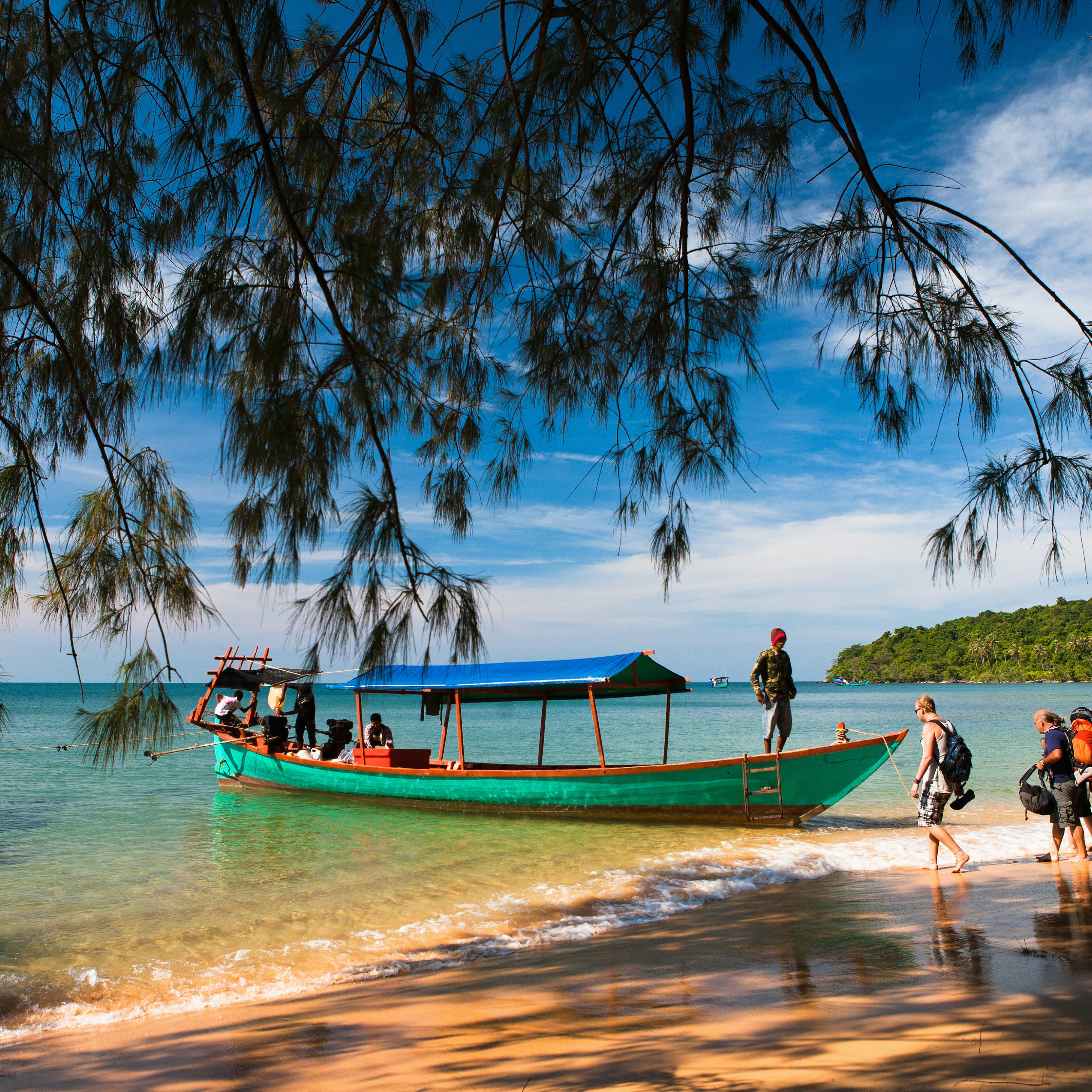 A boat picks up backpackers from secluded Koh Russei