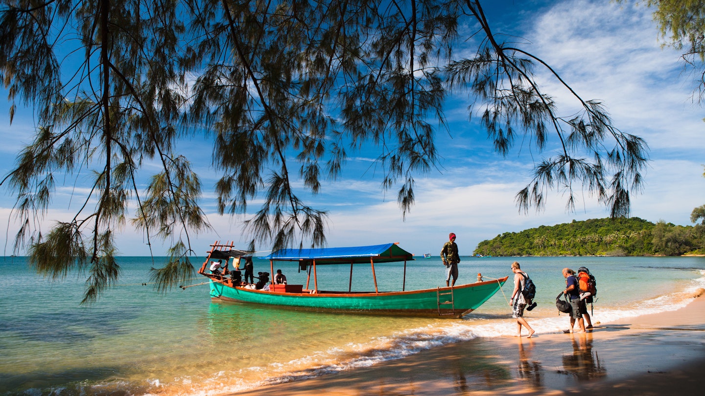 A boat picks up backpackers from secluded Koh Russei