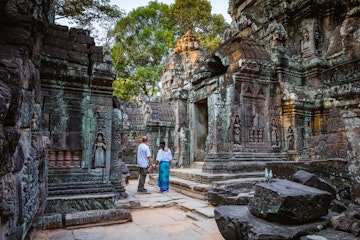 Adult couple of tourists visiting the temple ruins of Angkor, Siem Reap, Cambodia