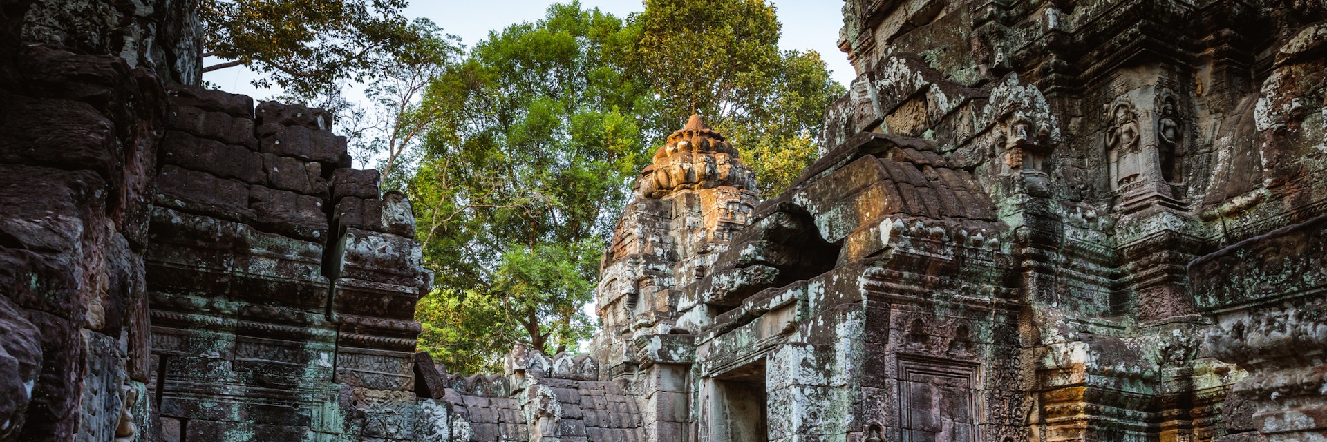 Adult couple of tourists visiting the temple ruins of Angkor, Siem Reap, Cambodia