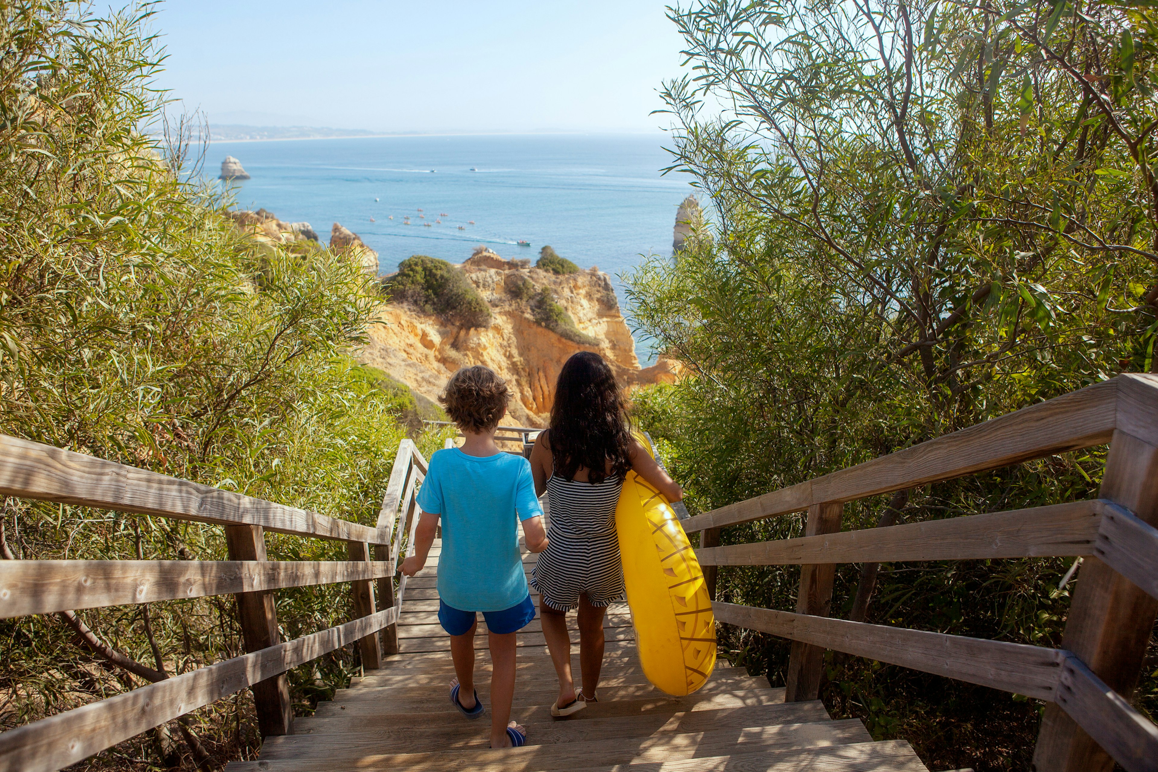 Two kids walking to the beach