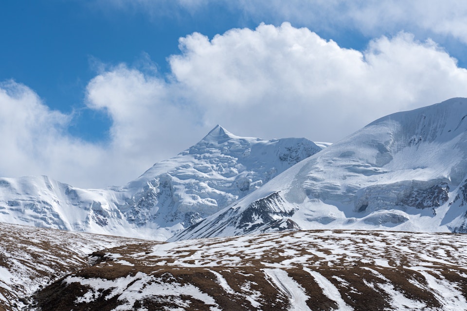 Close-up view of Mount Amnye Machen and its 6282m peak of Machen Kangri,   Amdo Tibet Region’s most sacred snow mountain. It's located in Qinghai Province, China. ; Shutterstock ID 2033099978; your: Bridget Brown; gl: 65050; netsuite: Online Editorial; full: POI Image Update