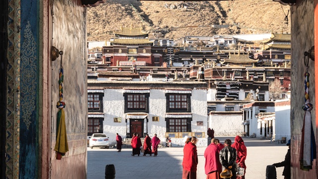 Shigatse, China - December 26 2018: Buddist monk walk in the traditional tashilhunpo monastery in Tibet province.