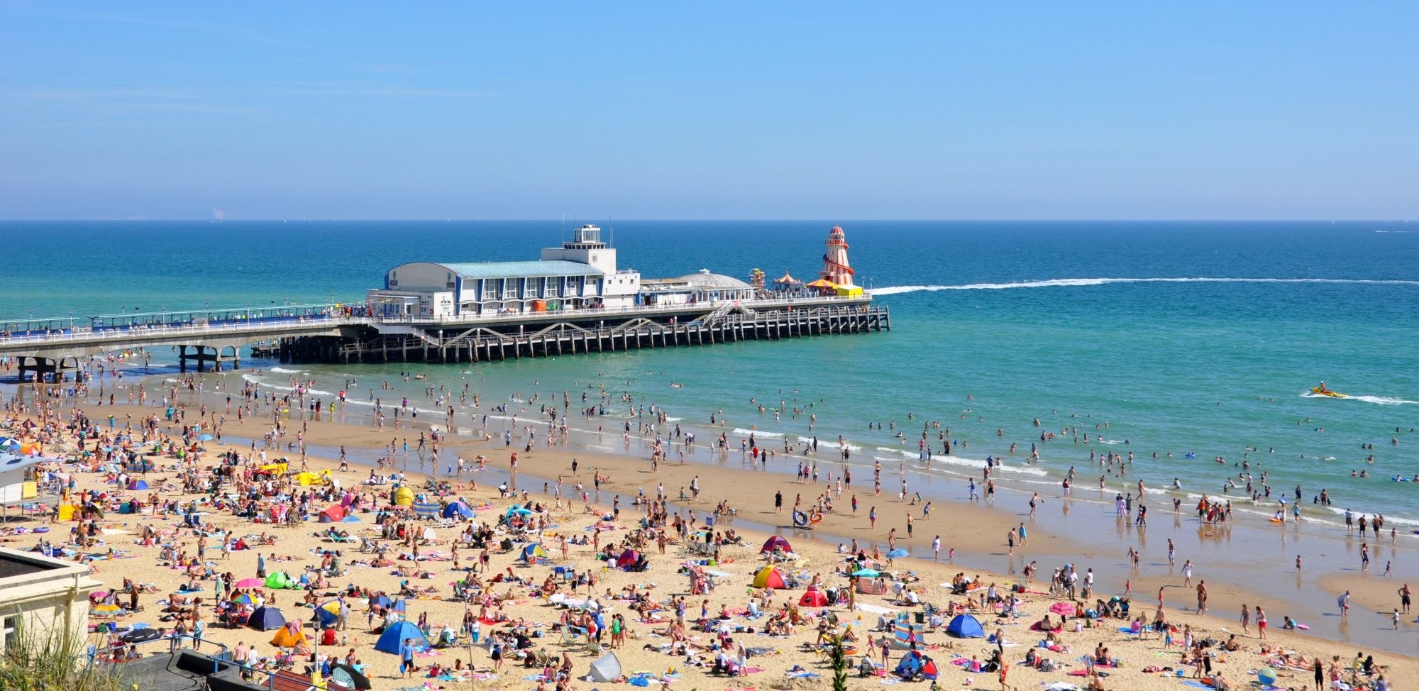 Detail of Bournemouth Pier and crowded beach.