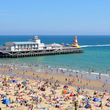 Detail of Bournemouth Pier and crowded beach.