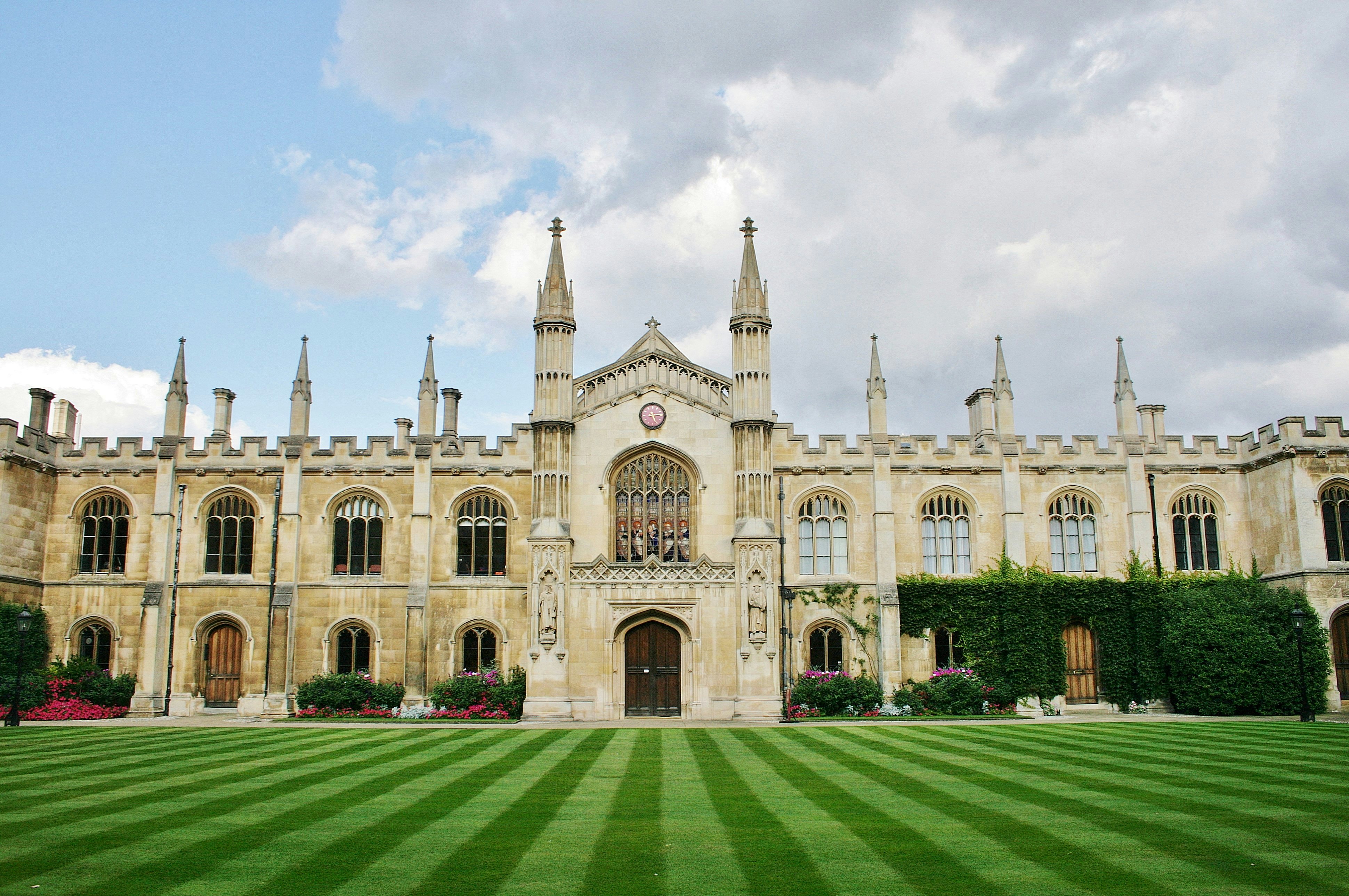 Cambridge, Cambridgeshire, England, U.K. 08/19/2014. Corpus Christi College with its beautiful lawn that rolls down to the River Cam is part of Cambridge University, England.