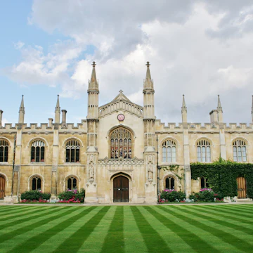Cambridge, Cambridgeshire, England, U.K. 08/19/2014. Corpus Christi College with its beautiful lawn that rolls down to the River Cam is part of Cambridge University, England.