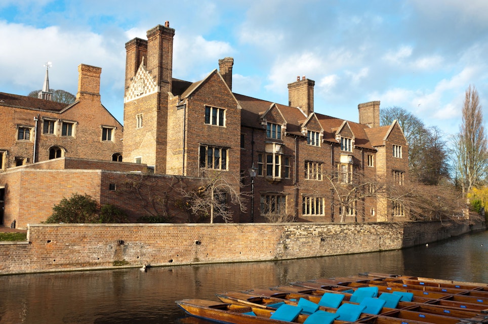Magdalene college, Cambridge University. Quayside view with punts moored on the bank of the River Cam