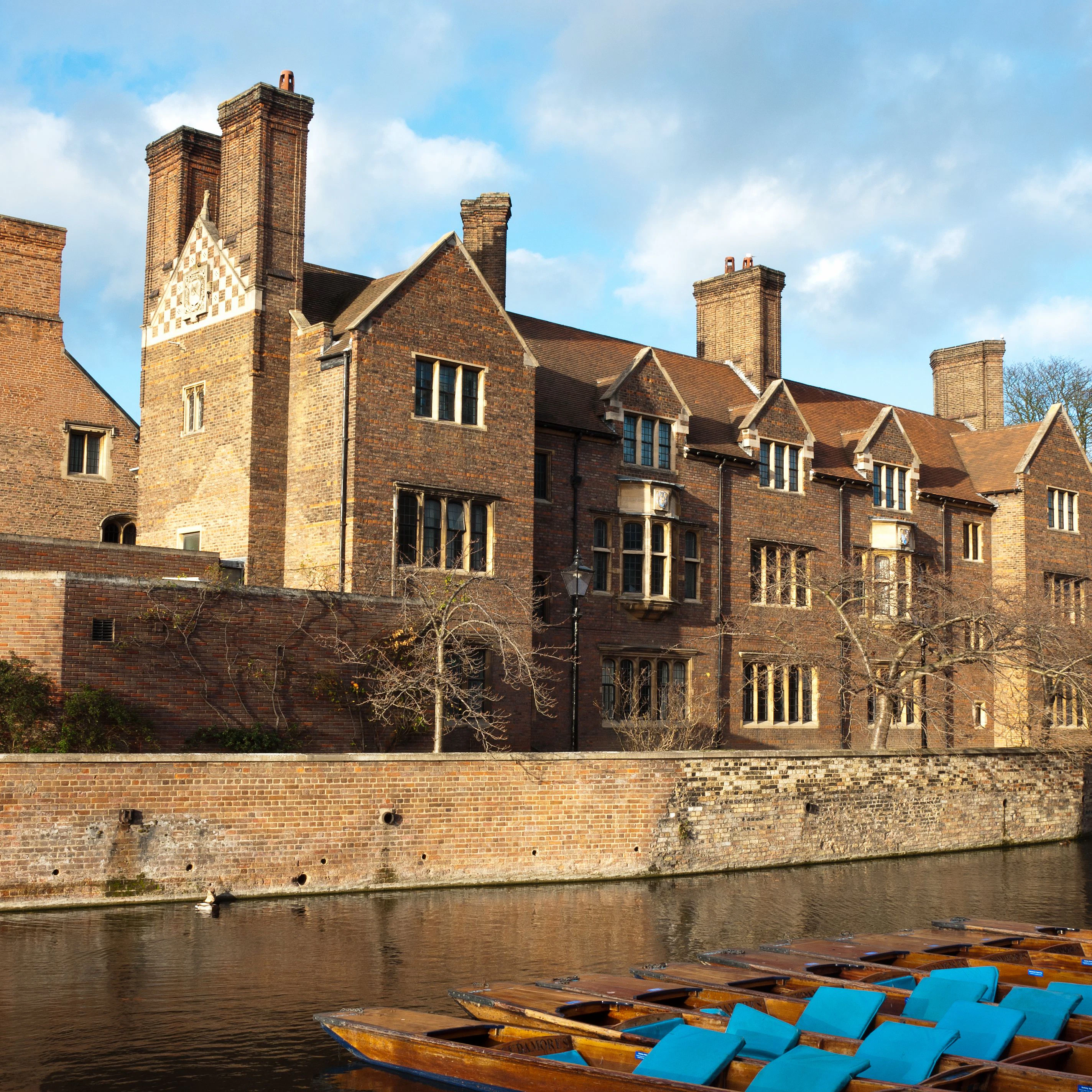Magdalene college, Cambridge University. Quayside view with punts moored on the bank of the River Cam