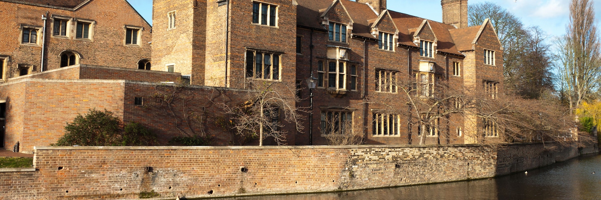 Magdalene college, Cambridge University. Quayside view with punts moored on the bank of the River Cam