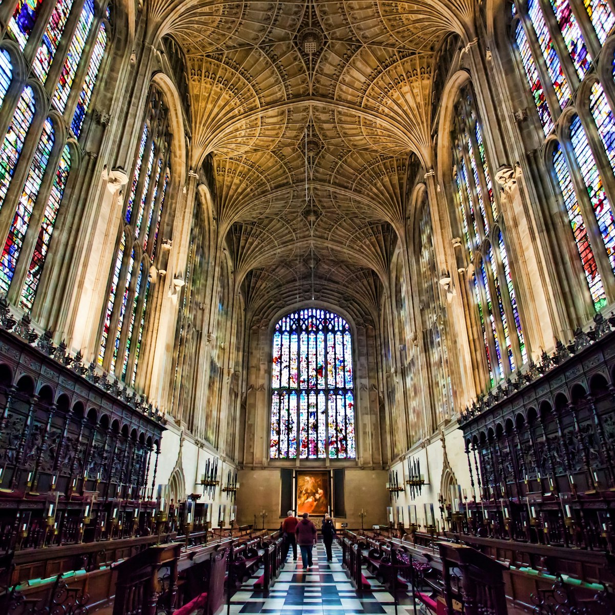 View inside Kings college Chapel Cambridge, showing the fan vault ceiling and vast wooden paneling, and amazing stain glass windows.