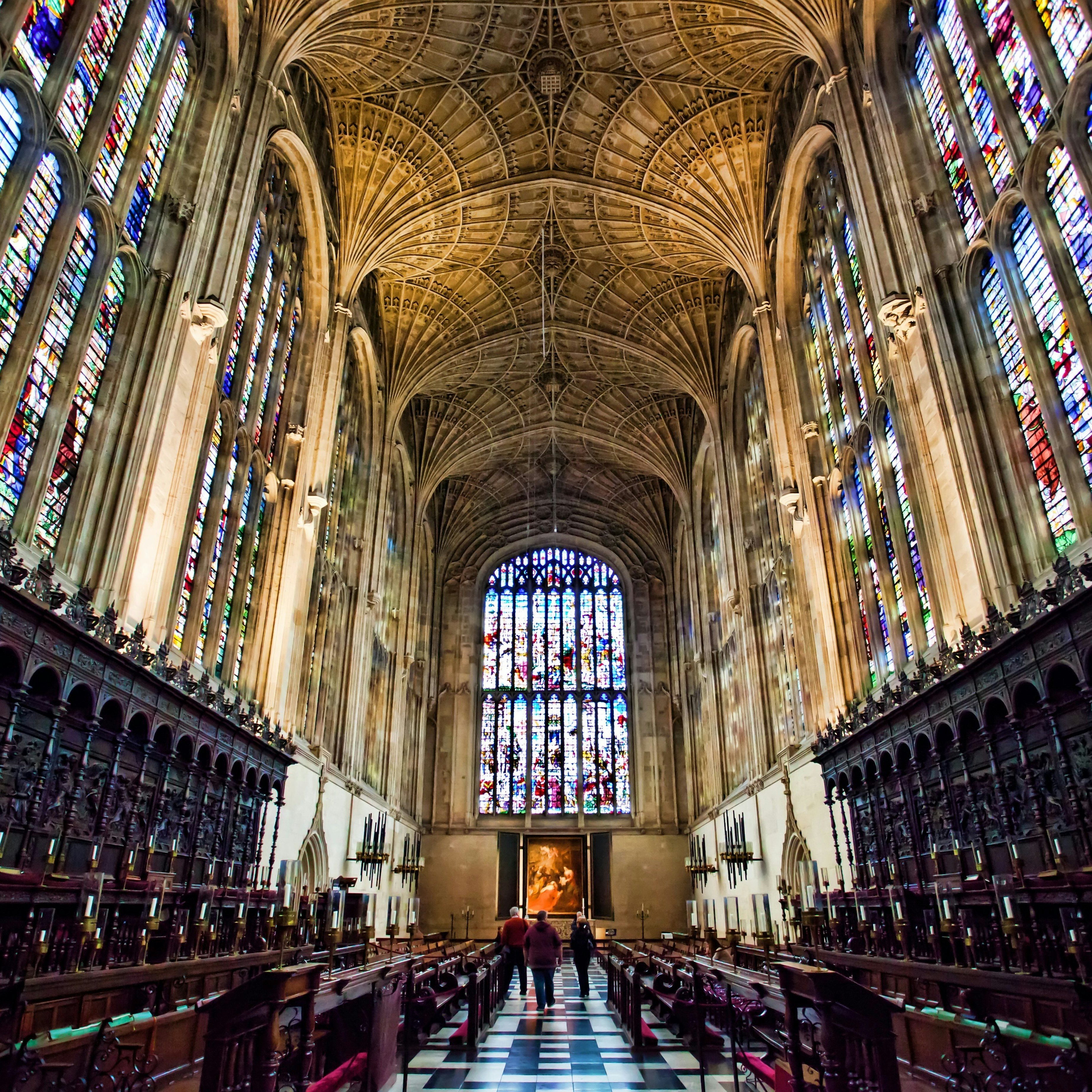 View inside Kings college Chapel Cambridge, showing the fan vault ceiling and vast wooden paneling, and amazing stain glass windows.