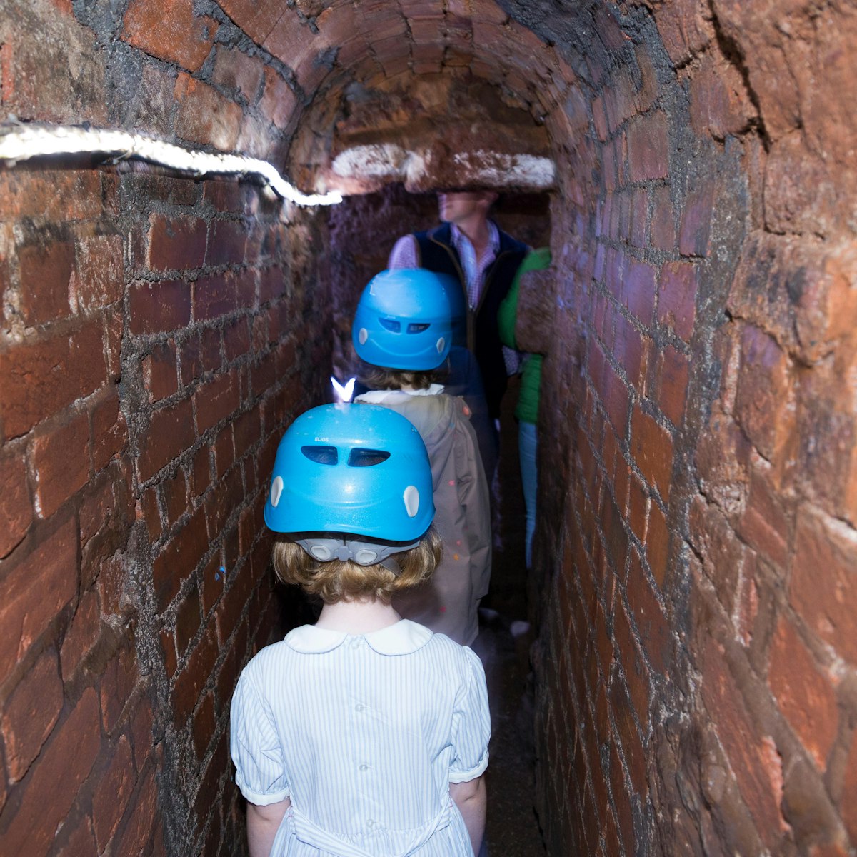 TYFKFC Family including children / kid / kids and young girl follow a group trip around Exeter's underground passages and tunnels, interesting destination for family tour of these ancient cut and cover tunnel network. UK (109)