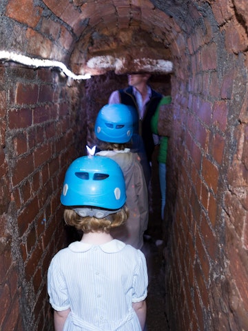 TYFKFC Family including children / kid / kids and young girl follow a group trip around Exeter's underground passages and tunnels, interesting destination for family tour of these ancient cut and cover tunnel network. UK (109)