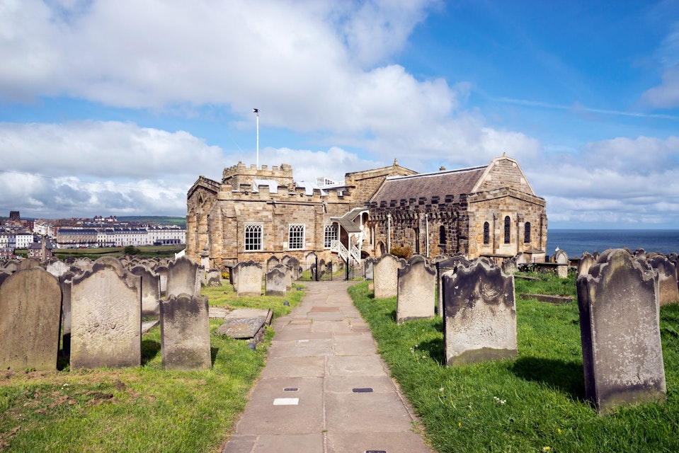 View of Whitby from St Mary's church, North Yorkshire, England - stock photo

Path in the graveyard beside this historic church on the cliff above the town of Whitby. A busy tourist destination with many attractions and a connection to the novel 'Dracula'.