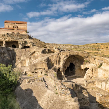 Uplistsikhe cave town near Gori city in Georgia. Ancient cave city Uplistsikhe at sunset in Georgia, UNESCO site.; Shutterstock ID 2108311661; your: Bridget Brown; gl: 65050; netsuite: Online Editorial; full: POI Image Update