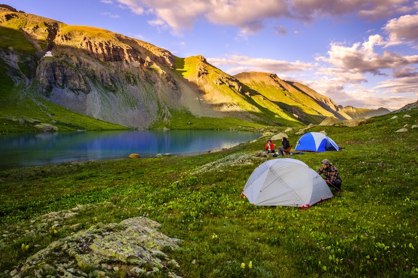 Clouds over small group of hikers camping in front of scenic Ice Lake, Colorado, United States
