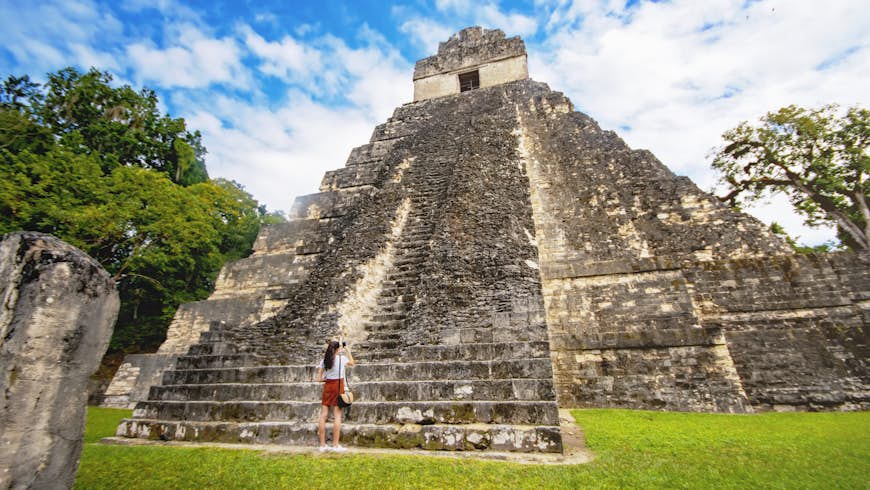 Woman in front of Temple of the Great Jaguar or Temple I in Tikal, Guatemala