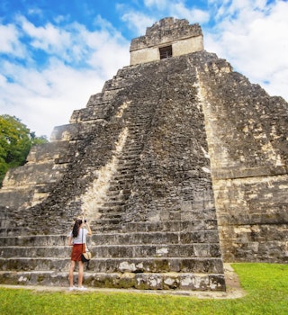 Woman in front of Temple of the Great Jaguar or Temple I in Tikal