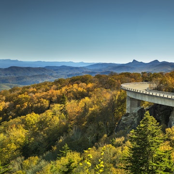 Linn Cove Viaduct Blue Ridge Parkway in autumn

Cars travel on the Linn Cove Viaduct highway road on the Grandfather Mountain along the Blue Ridge Parkway in autumn North Carolina USA