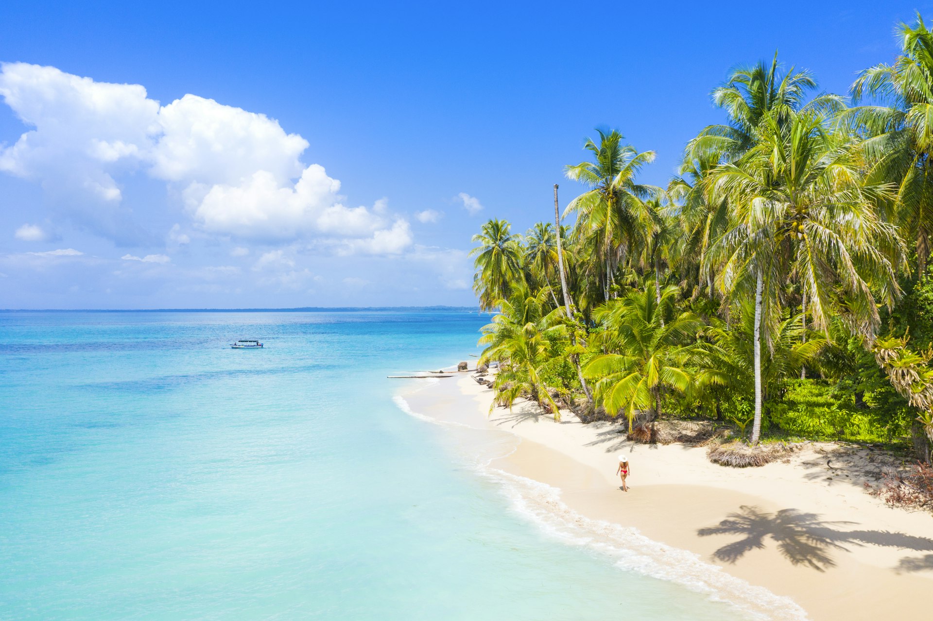 Woman walking on the beach in the Bocas del Toro islands. Zapatilla island, Panama