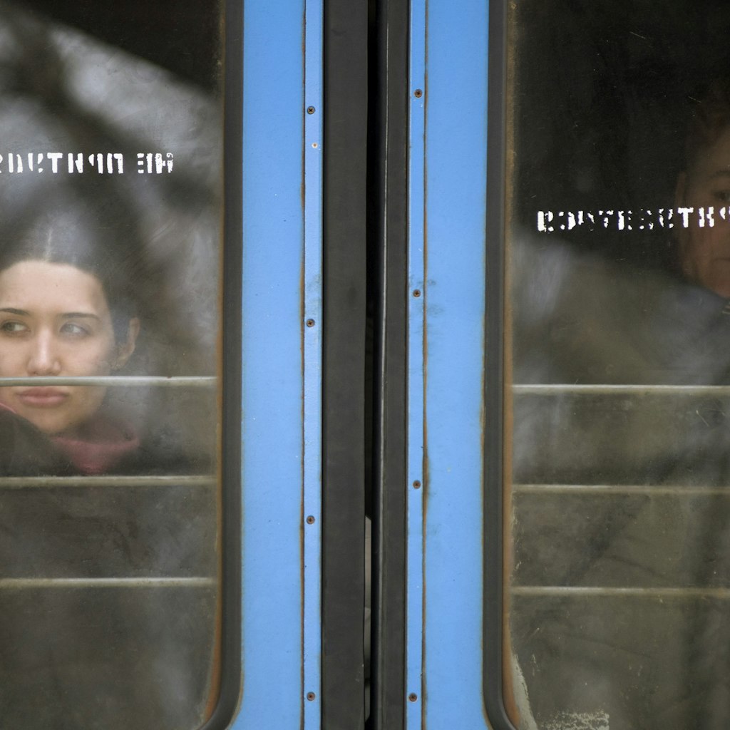 PRZEMYSL, PODKARPACKIE, POLAND - 2022/02/28: Ukrainian women are looking through out the train window at the station in Przemysl..On the fifth day of the Russian invasion on Ukraine, thousands of asylum seekers arrive by trains to Przemyl. Each train's capacity is estimated at two thousand people. (Photo by Attila Husejnow/SOPA Images/LightRocket via Getty Images)