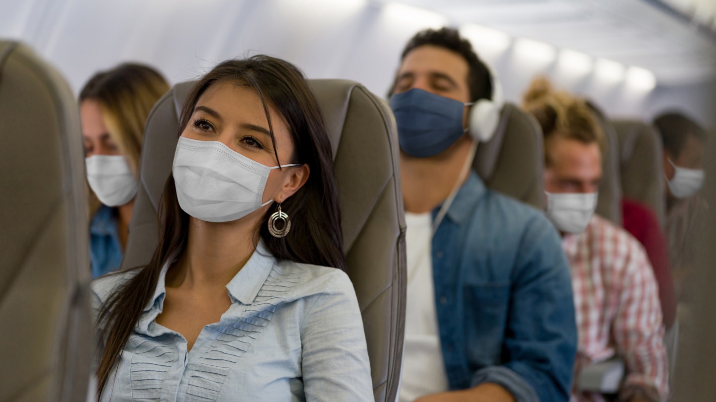 People wearing masks on a plane.