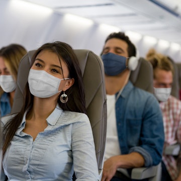 People wearing masks on a plane.