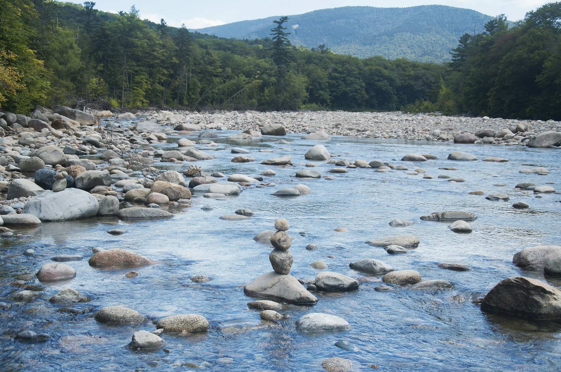 A rock cairn in the middle of a river