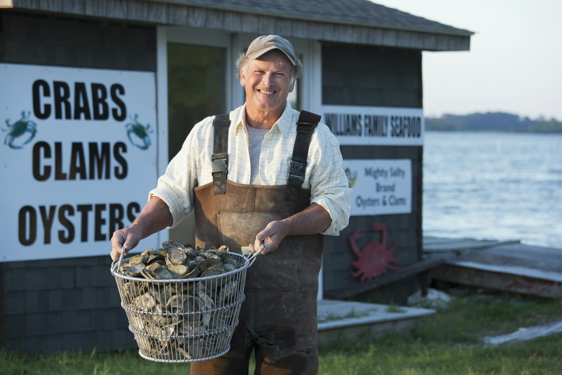 Fisherman holding basket of oysters