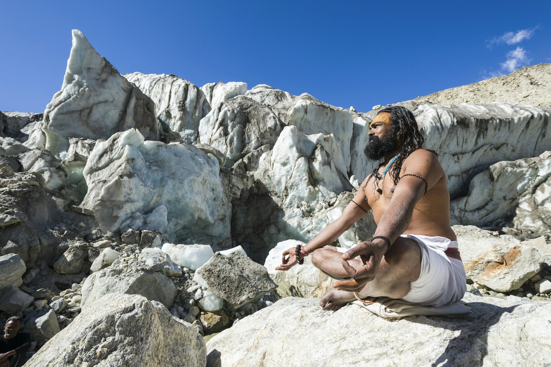 A sadhu (holy man) meditating on a rock at Gaumukh, the source of the holy River Ganges