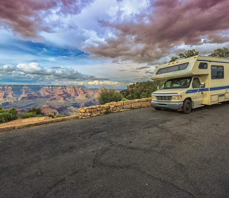 Magnificent view of the Grand Canyon with RV making a stop in the mountain heights at sunset