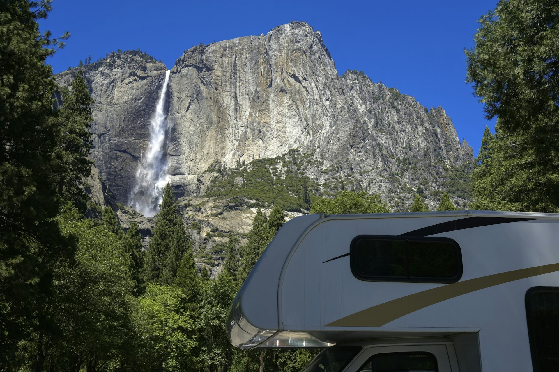 RV camper with a waterfall at Yosemite National Park, California